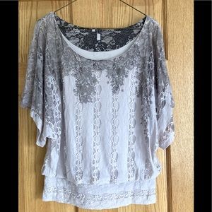 Women’s light pink/lavender short-sleeved blouse.